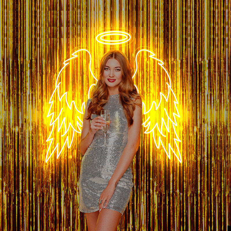 Girl in sparkly party dress posing infront of a golden yello Angel Wings and Double Halo LED neon sign